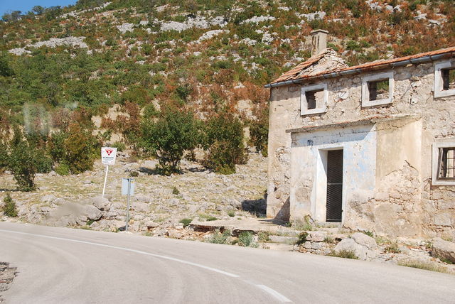 Zahlreiche Ruinen aus dem Kroatienkrieg säumen den Straßenrand.