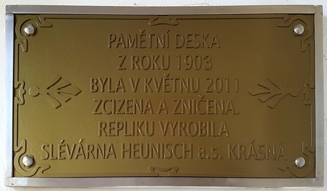 &#8222;Die Gedenktafel aus dem Jahre 1903 wurde im Mai 2011 entfremdet und zerstört. Die Replik wurde angefertigt von der Gießerei Heunisch in Krásná (Schönbach bei Asch).&#8220;